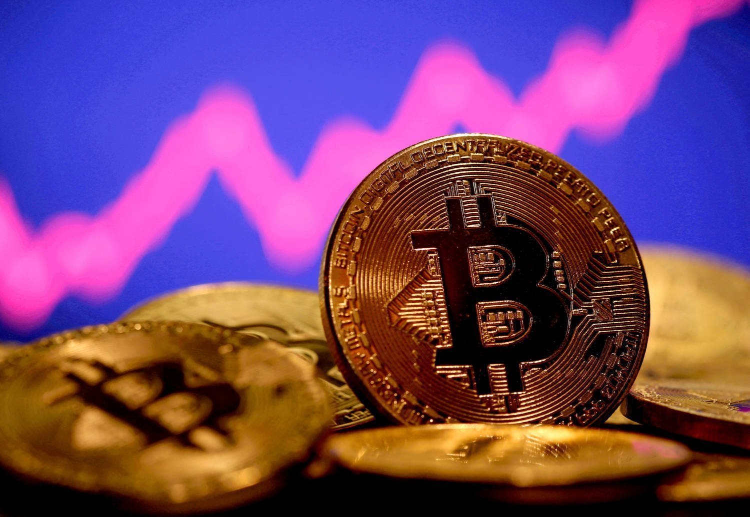 File Photo: A Representation Of Virtual Currency Bitcoin Is Seen In Front Of A Stock Graph In This Illustration Taken