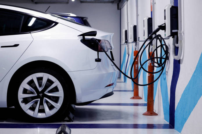 File Photo: An Electric Vehicle Is Plugged Into A Charging Station In Bilbao