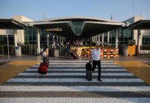 File Photo: People Walk With Their Luggage Outside Larnaca International Airport, In Larnaca