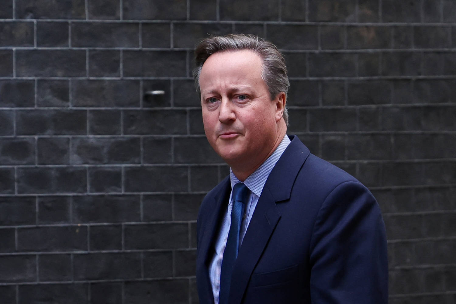 Former British Prime Minister David Cameron Walks Outside 10 Downing Street In London