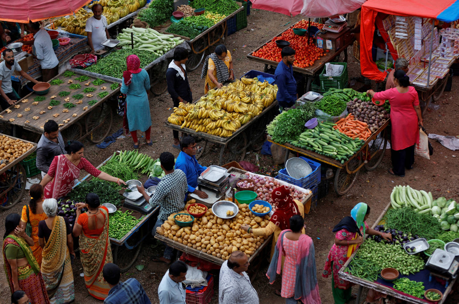 File Photo: Customers Buy Fruits And Vegetables At An Open Air Evening Market In Ahmedabad