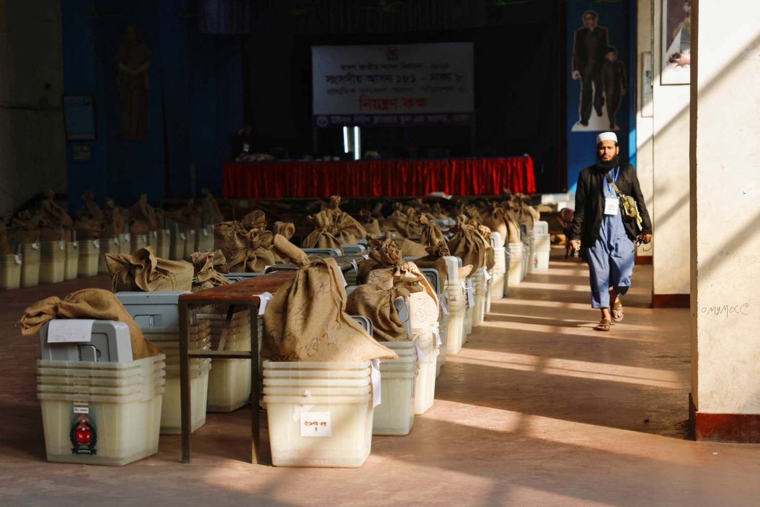 An Official Walks Past Ballot Boxes That Are Stored At A School Before Being Distributed To The Voting Centres, Ahead Of The General Election In Dhaka