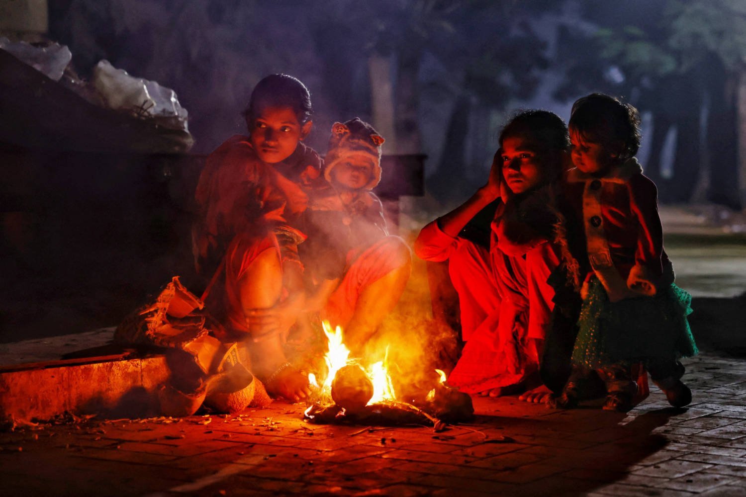 Homeless People Who Live At The Suhrawardy Udyan Light A Fire To Warm Themselves, As Temperature Drops Significantly During Winter In Dhaka