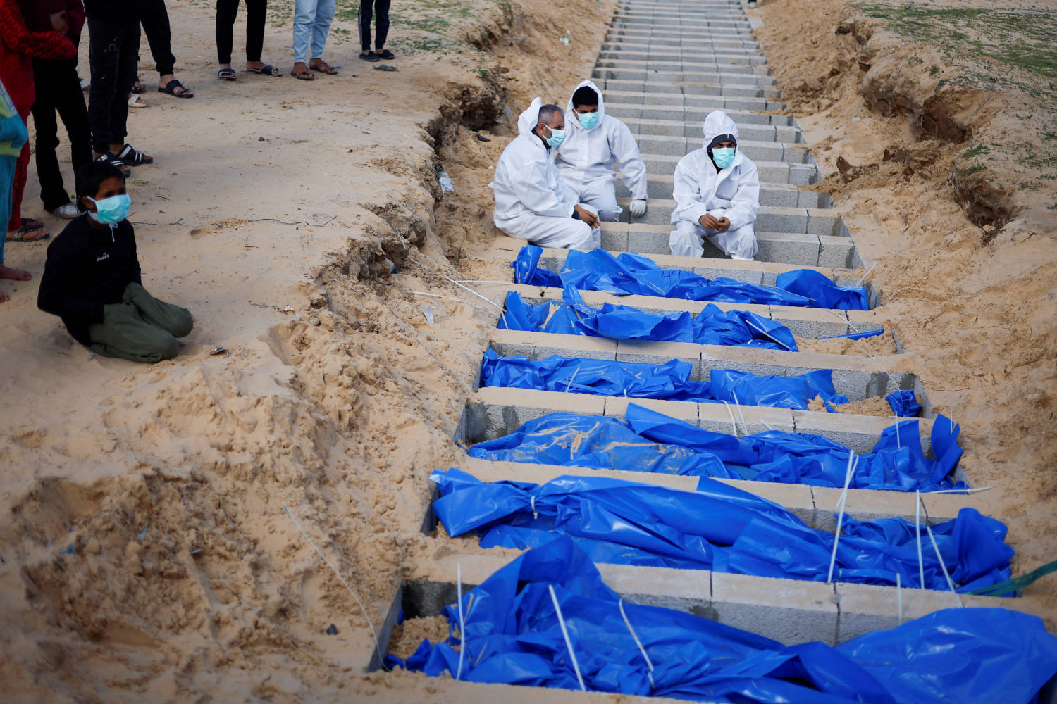 People Bury Palestinians, Including Those Who Were Killed In Israeli Strikes And Fire, After Their Bodies Were Released By Israel, In Rafah