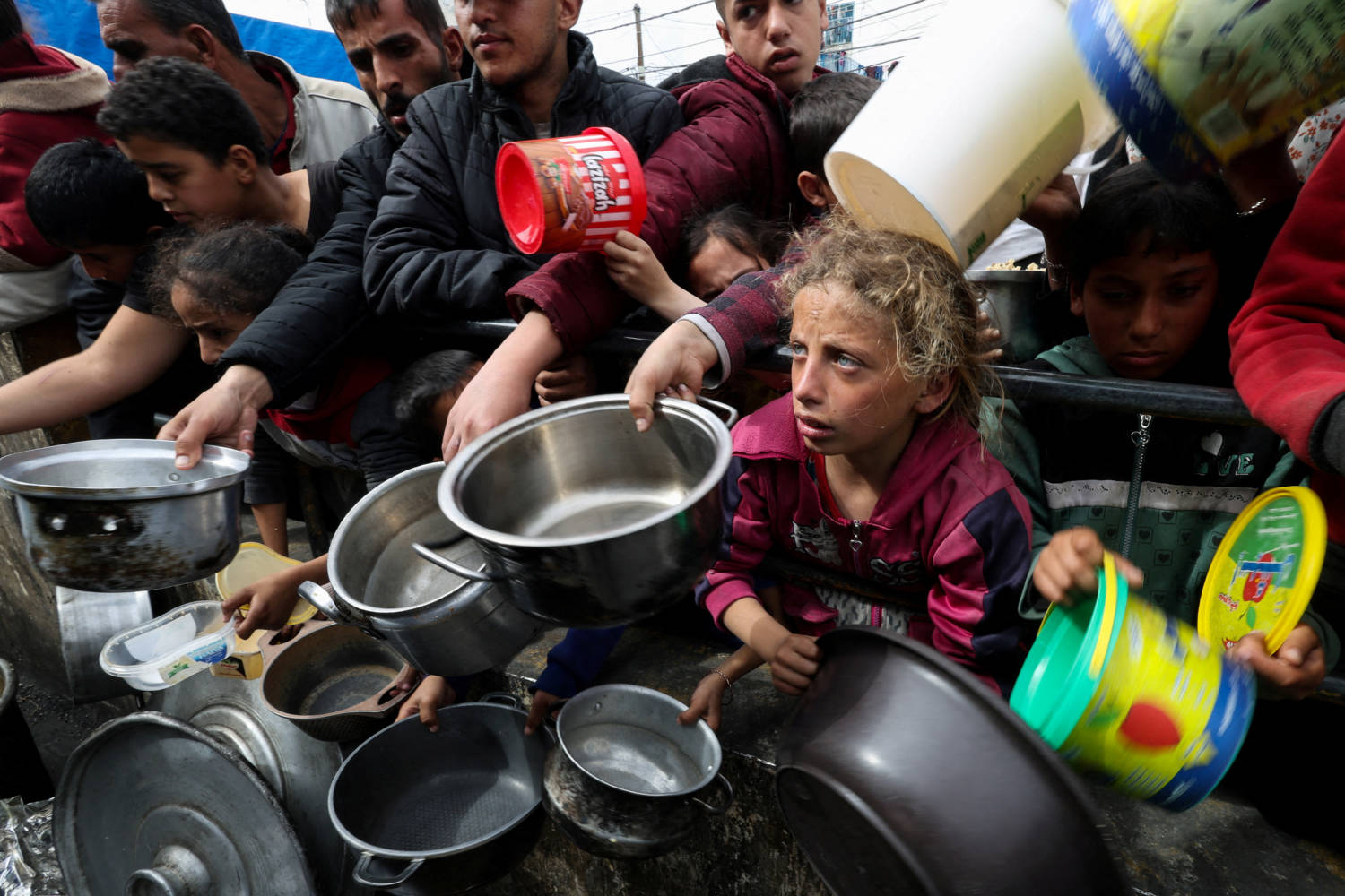 Palestinian Children Wait To Receive Food Cooked By A Charity Kitchen Amid Shortages Of Food Supplies, In Rafah