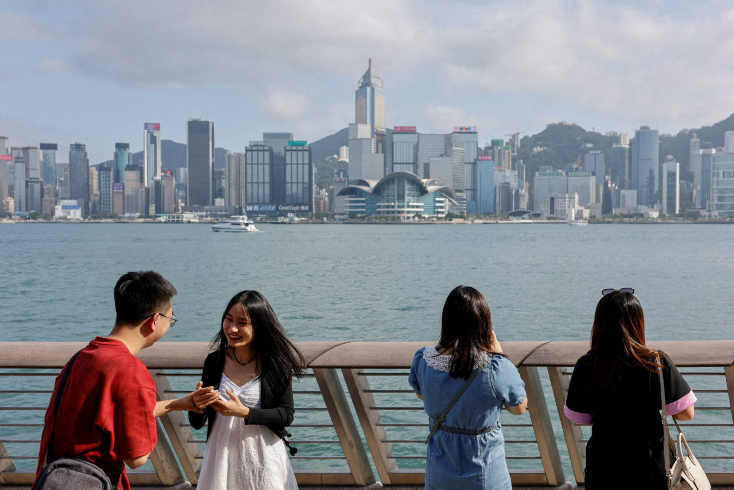 File Photo: File Photo: Mainland Chinese Tourists Take Photo Of The Skyline Of Buildings At Tsim Sha Tsui, In Hong Kong