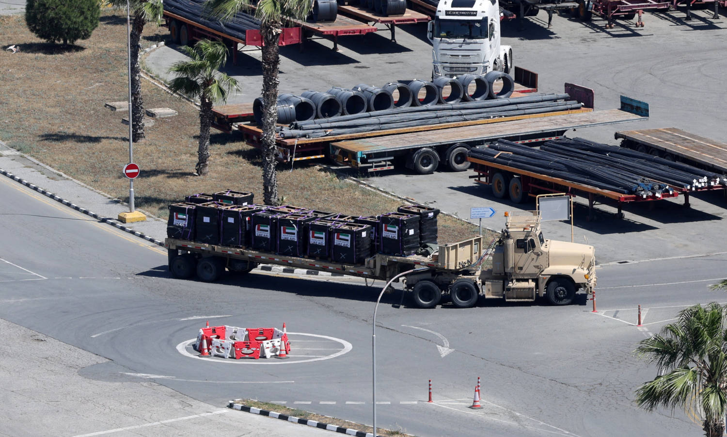 A Truck Carries Cargo With Uae Flags On It At The Port Of Larnaca