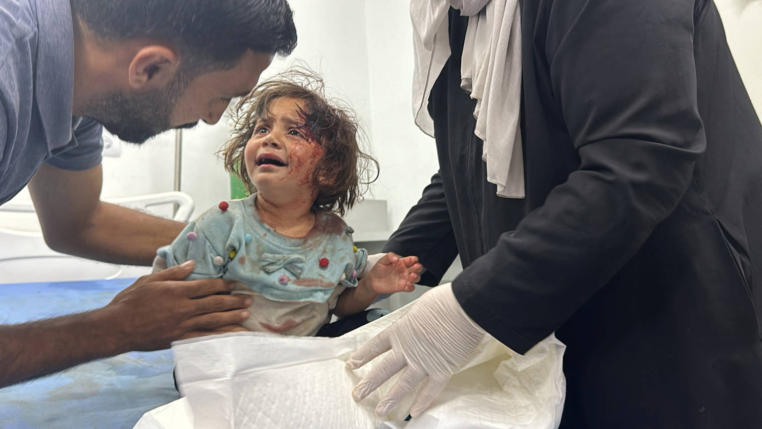A Palestinian Child, Wounded In An Israeli Strike On An Area Designated For Displaced People, Is Assisted At A Hospital, In Rafah