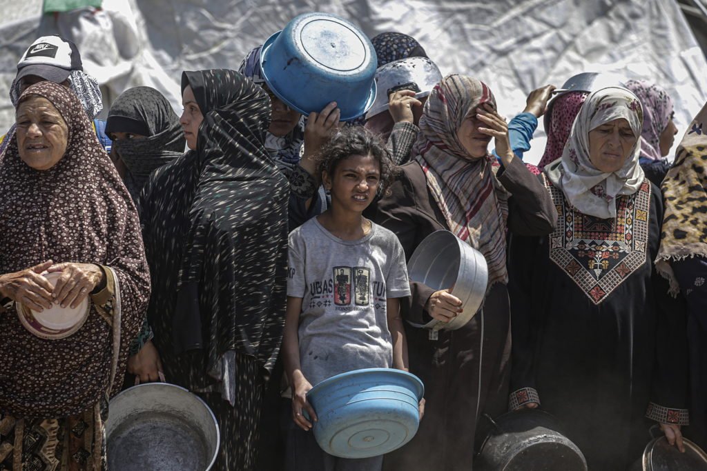 Displaced Palestinians Collect Donated Food In Jabalia, Northern Gaza