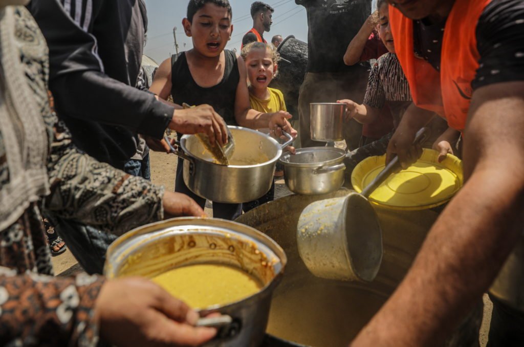 Displaced Palestinians Collect Donated Food In Jabalia, Northern Gaza