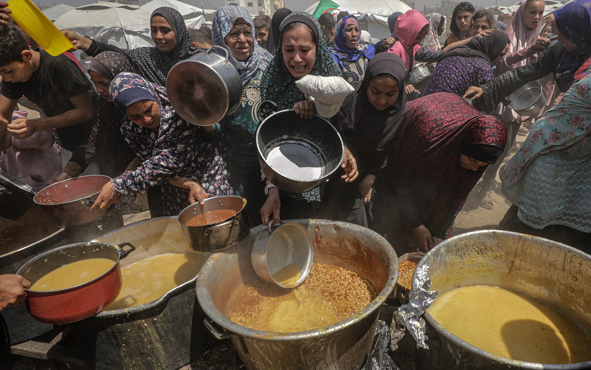 Displaced Palestinians Collect Donated Food In Jabalia, Northern Gaza