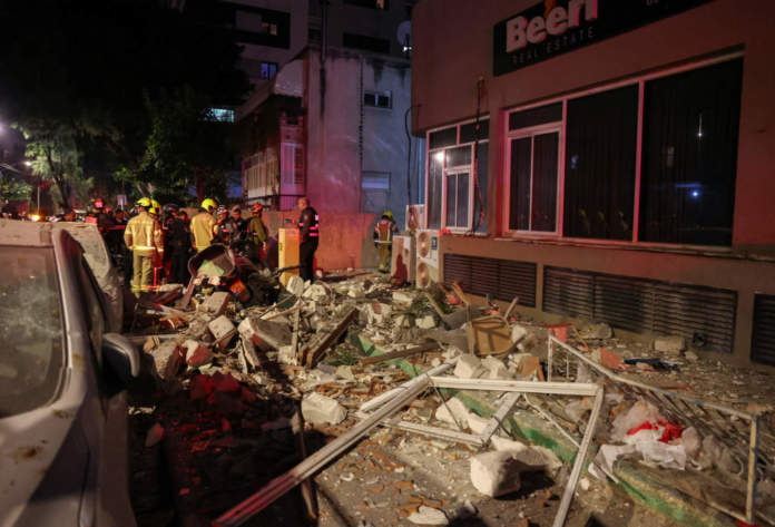 Emergency Personnel Inspect Damage In A Building Following An Iranian Projectile Strike, Amid The U.s. Israeli Conflict With Iran, In Central Israel